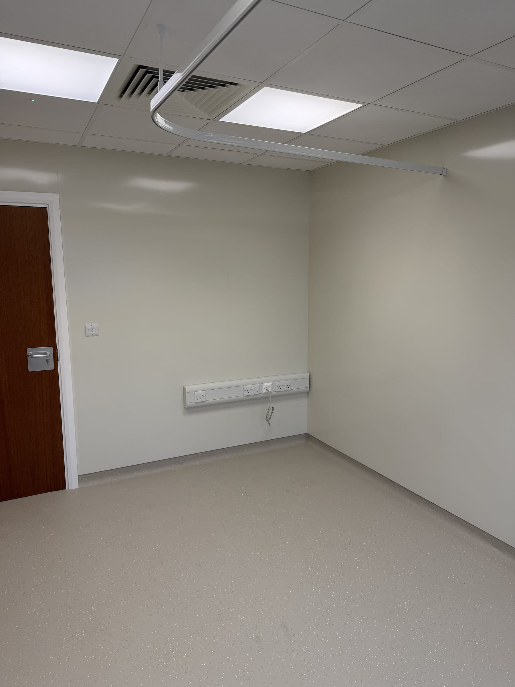 Refurbished clinical room with hygienic wall cladding and ceiling ventilation