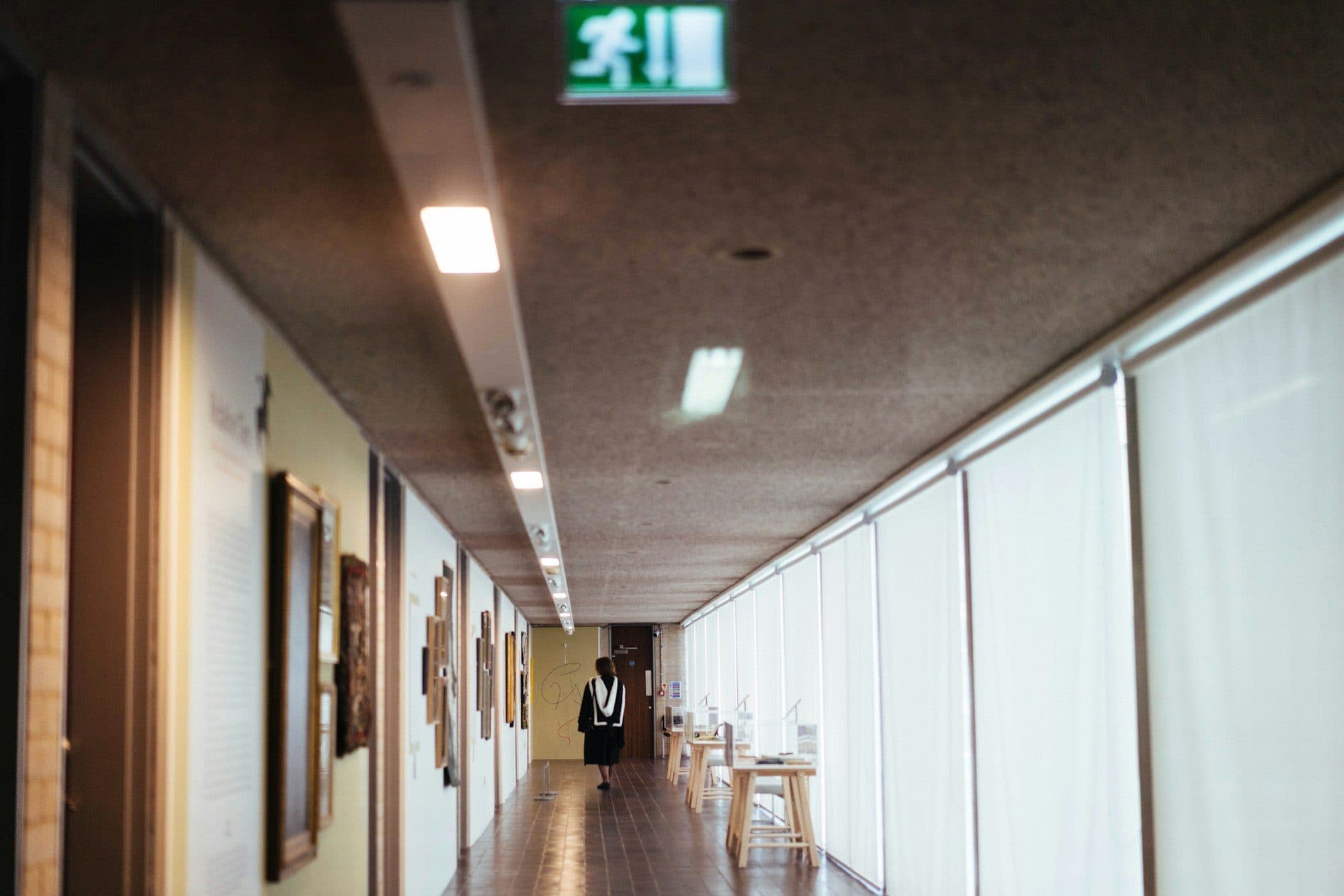 School corridor with an illuminated emergency exit sign